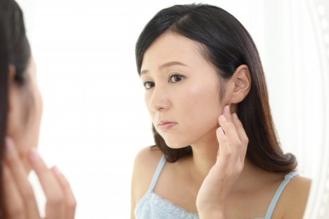 頬骨の張りやむくみが気になり悩む女性